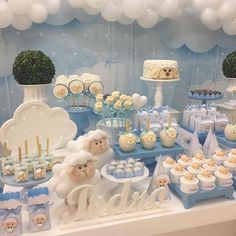 a baby shower party with blue and white decorations, teddy bears, cake and cupcakes