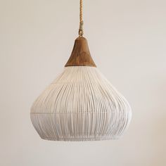 a white light hanging from a wooden ceiling