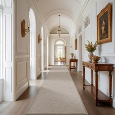 the hallway is clean and ready for guests to use it as an entrance way in this house