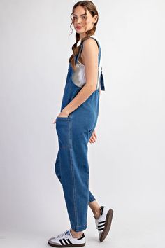 Mineral washed solid sleeveless jumpsuit featuring adjustable straps, a scoop neckline, two open front pockets and is a straight leg style. Model is 5'9" and wearing a small.75%COTTON 23%POLYESTER 2%SPANDEX Casual Shortalls With Side Pockets, Spring Medium Wash Overalls With Adjustable Straps, Trendy Overalls With Adjustable Straps, Casual Dark Wash Denim Jumpsuit With Side Pockets, Summer Medium Wash Overalls With Adjustable Straps, Medium Wash Overalls With Adjustable Straps For Summer, Casual Cotton Jumpsuits And Rompers With Tie Straps, Casual Solid Jumpsuits And Rompers With Adjustable Straps, Relaxed Fit Overalls With Adjustable Straps For Spring