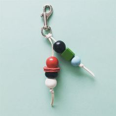 a keychain with two different colored objects attached to it's hooks