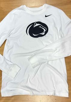 Nike Penn State Nittany Lions White Logo Long Sleeve T Shirt - 12554018 Nike Long Sleeve Fan Gear Top, Sportswear Tops With Team Logo And Crew Neck, Sportswear Crew Neck Top With Team Logo, Nike College Tops With Team Logo, Sporty Jersey Tops With Team Logo, Long Sleeve Tops With Team Logo For Sports Events, White Moisture-wicking Top For Sports Fans, Nike Collegiate Tops With Team Name, Sports Jersey Top With Team Logo