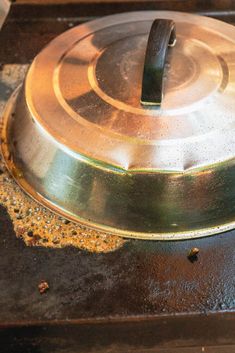 a metal pan sitting on top of a stove