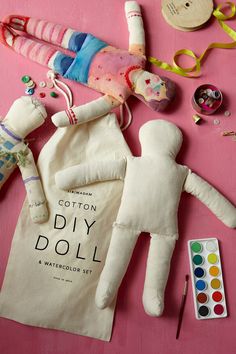 a stuffed animal and other craft supplies on a pink tablecloth with the caption diy doll