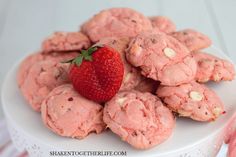 a white plate topped with cookies and a strawberry