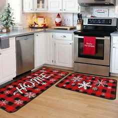 two kitchen mats with the words home and snowflakes on them in front of an oven