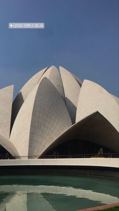 the lotus shaped building is next to a body of water