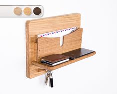 a wooden holder with two credit cards and a wallet attached to the side of it