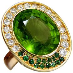 Oval Cut Peridot Cluster 21.00ct. Natural Peridot ring. Oval cut, clean clarity & Transparent. Classic Green Color Clean clarity 19 X 16.5mm 1.00ct Side round diamonds Full cut Brilliants G-color Vs-2 Clarity .50ct round green natural demantoid 14kt. yellow gold 26.8 grams. Ring is 1.18 inch X .99 inch (Top Deck) Depth: .55 inch current ring size: 5 We may resize, please inquire. $18,000 Appraisal Certificate to accompany Fancy Yellow Diamond Ring, Christmas Photo Album, Demantoid Garnet, Peridot Jewelry, Yellow Diamond Rings, Purple Jewelry, Gold Cocktail Ring, Natural Diamond Ring, Gold Cocktail