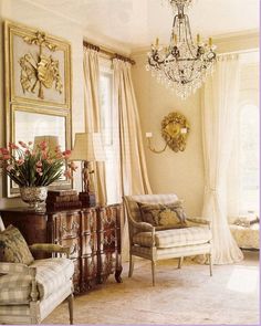 a living room filled with furniture and a chandelier