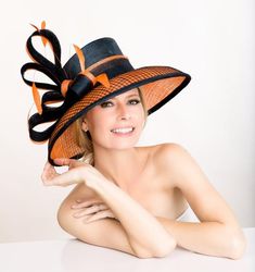 Elegantly styled, this hat is perfect for the opening day at the race track, tea luncheons, weddings and other special occasions. Orange hat covered with navy basket weave sinamay . The navy orange trimmed loops and feathers complete this style. Wear it at the weddings, or church or Ascot or Derby Formal Hat, Barbie Hat, Orange Hat, Royal Ascot Hats, Navy Hat, Couture Hats, Beige Hat, Ascot Hats, Hat Wedding