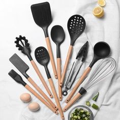 an assortment of kitchen utensils on a white cloth