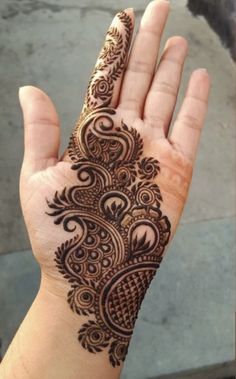 a hand with a henna tattoo on it's palm and the bottom half of its arm