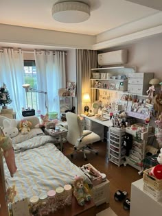 a room with a bed, desk and shelves filled with stuff on top of it