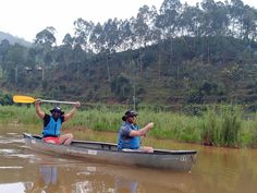 two people in a canoe paddling down a river