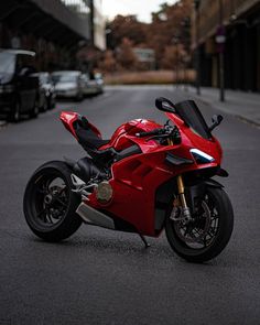 a red motorcycle is parked on the street