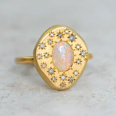 Our pebble collection of raw, rough, beaten metals set with precious gems. Perfectly imperfect and all one of a kind. A magical crystal opal from Coober Pedy is surrounded by star set salt and pepper diamonds. Opal measures approx. 7 x 5mm. Pebble measures approx. 17.5 x 15mm. Band width approx. 1.8mm. Gold weight approx. 5.8g in 14ct, 6.6g in 18ct. Pictured with a matte finish. For a high shine finish on the band, please leave a note at checkout. Please note, we will match the opal as close to the image as possible. Each opal is unique and may vary in appearance and colour from what is depicted on the site. Magical Crystal, Pebble Ring, The Bling Ring, Coober Pedy, Jewellery Inspiration, Crystal Opal, Salt And Pepper Diamond, Opal Crystal, Precious Gems