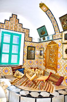 an artistic room with colorful walls and pictures on the wall