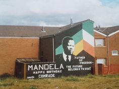 a large mural on the side of a building with a mandela message painted on it