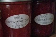 three jars with labels on them sitting on a shelf