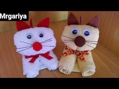 two stuffed animals sitting on top of a wooden table