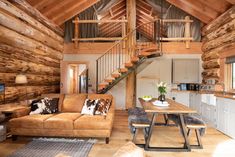 a living room filled with furniture next to a wooden floor covered in lots of wood