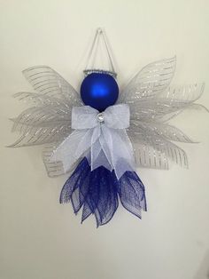 a blue ornament hanging from the side of a wall