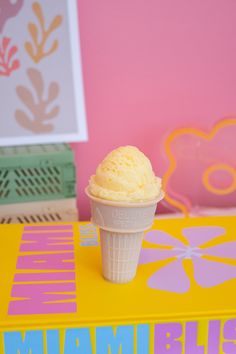 an ice cream cone sitting on top of a yellow box