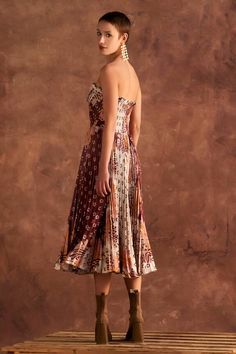 Brown strapless dress with all over printed floral abstract motifs, bodice pleats and frill detail. - Aza Fashions