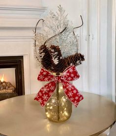 a vase filled with pine cones on top of a table