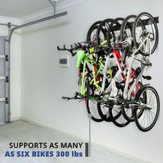 there is a bike rack in the garage with bikes on it's sides and two doors open