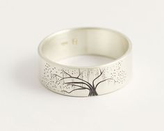 a silver ring with a tree on it