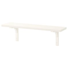 a white shelf sitting on top of a wall