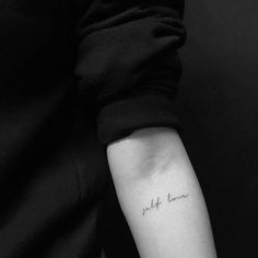 a person with a small tattoo on their arm that says, i am not here