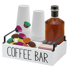 a coffee bar with cups, saucers and spoons in a tray on a white background