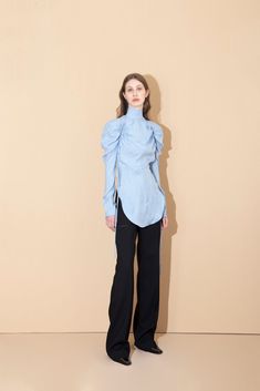 Incorporating a minimalism that celebrates sleek modern fashion into each collection; it's evident with this effortless blouse, that Aleksandre Akhalkatsishvili is trying to reimagine the way women dress. Cut into a relaxed silhouette, detailed with long ruched sleeves, a mock-collared neckline, and modernized with cut outs at the shoulders; perfect for any occasion. -- Product Details Composition: 100% Cupro Slim Fit Zip fastening at back Cut Out detailing at shoulders Long sleeves Unlined