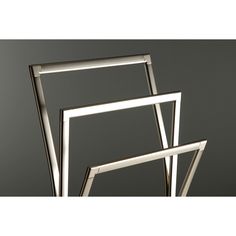 three metal frames stacked on top of each other in front of a gray background with the word