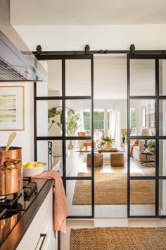 an open kitchen and living room with sliding glass doors