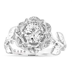 a white gold ring with a flower design