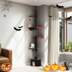 a living room decorated for halloween with pumpkins and bats on the wall, two cats sitting on shelves