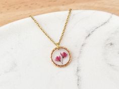 Silver Listing - https://www.etsy.com/uk/listing/1510947161 This little textured necklace features some real little Japanese Blossom flowers which are encapsulated in a clear resin. This is a simple yet beautiful necklace which would make the perfect birthday or bridesmaid gifts.