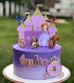 there is a purple cake with princess characters on it and the name sophia