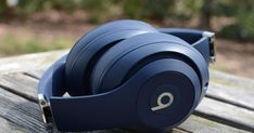 headphones sitting on top of a wooden table