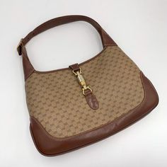 Please add your phone number on your order to avoid delays.Please keep in mind that all sales are final so please know that and ask all your questions before purchasing this. delays.100% Authentic Vintage Gucci monogram Jackie Shoulder Bag- Material: PVC canvas, leather - Hardware: Gold toned of hardware turned to silver- Color: Brown , Beige - The label logo inside reads “GUCCI MADE IN ITALY”- Inside: Removed all the peelings and left the soft cotton material underneath- Outside: some signs of Vintage Designer Bags, White Shoulder Bag, Gucci Vintage, Gucci Monogram, Leather Hardware, Vintage Purse, Brown Beige, Canvas Leather, Gucci Jackie Bag