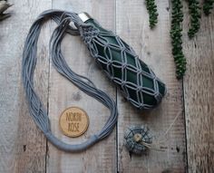 a green and gray bag sitting on top of a wooden floor next to other items