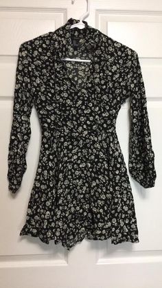 Good pre-owned condition Black & White Floral Long-sleeved Dress. Has a small 2inch splitting seam section near the armpit above the side zipper upon quick inspection of the dress. Zipper is tested and working. Unknown Age. Brand is "Forever 21". Tag says size is "S" (Small). Exact item is pictured above. Approximate Measurements - 26 inches Long - Shoulder to Hem - (Measure top of shoulder straight down to bottom hem)  - 32 inches - Bust - (Measure under armpits across garment and double) - 24 Grunge Long Sleeve Party Dress, Black Grunge Dress For Fall, Vintage Black Long Sleeve Dress, Flowy Long Sleeve Vintage Mini Dress, Grunge Long Sleeve Fitted Dress, Fitted Long Sleeve Grunge Dress, Black Long Sleeve Dress With Floral Print, Vintage Flowy Long Sleeve Mini Dress, Gothic Long Sleeve Mini Dress For Fall