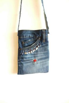 a handbag made out of jeans hanging on a wall