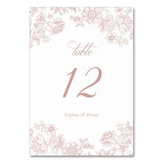 a wedding table number card with pink flowers