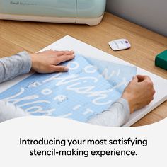 two people are working on a piece of paper with the words stencil - making experience