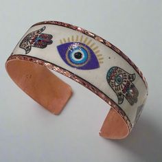 Copper Bangle with Enamel Evil Eye and Hamsa Designs - Sacred Crystals Bracelets Adjustable Enamel Bangle As A Gift, Adjustable Enamel Bangle As Gift, Adjustable Enamel Bangle For Gift, Hand Painted Bohemian Bangle Jewelry, Bohemian Hand Painted Bangle Jewelry, Bohemian Hand-painted Bangle Jewelry, Spiritual Copper Bangle, Adjustable Hand Painted Bangle Jewelry, Hand Painted Spiritual Jewelry For Festivals